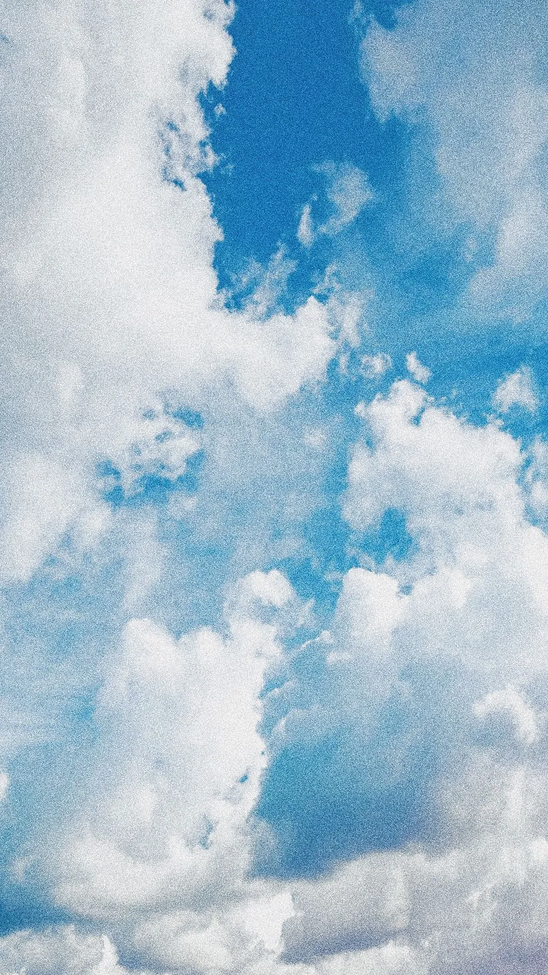 Grainy blue sky with clouds